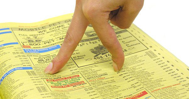 Walking Fingers Yellow Pages finders walking across a phonebook
